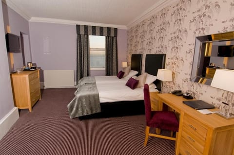 Recharge in a spacious twin setup with soft throws and lamps.