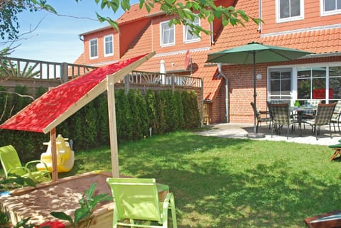 Garden with sandpit and children's toys.
