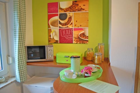 Kitchen counter with microwave and second fridge.
