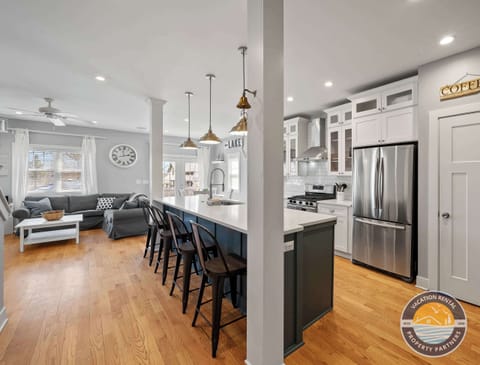 Open-concept layout with island seating and dining space.