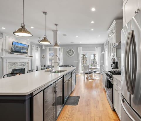 Long kitchen view with stainless appliances and plenty of counter space.