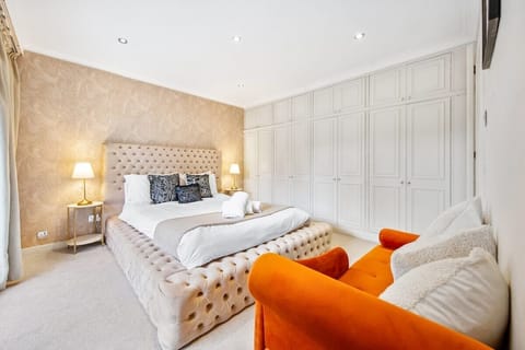 Stylish and cozy bedroom with a plush king bed, ample storage, and a vibrant touch of color — perfect for a relaxing stay.