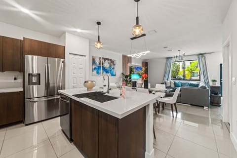 The fully equipped kitchen seamlessly flows into the dining area