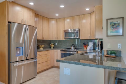 The open kitchen with breakfast bar and adjacent dining space makes entertaining effortless.