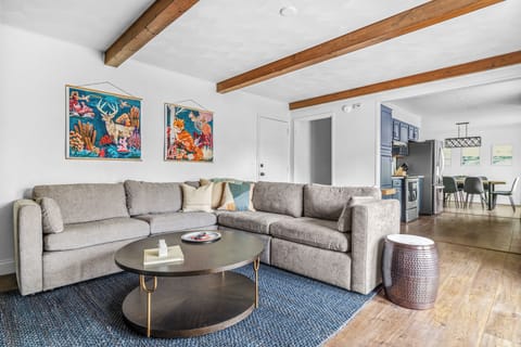 Kick back in this chic retreat with comfy seating, warm wood accents, and room for everyone to relax.