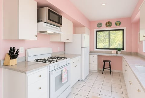 The retro kitchen has been outfitted with modern amenities while still being tastefully preserved in its original finishes.