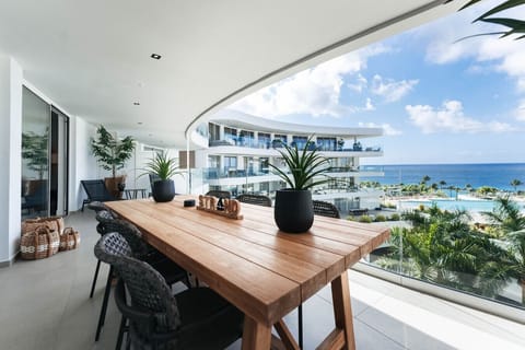 Spacious balcony with comfortable seating and beautiful views of the pool and ocean—an ideal spot to relax, enjoy the breeze, and take in the scenery at One Mambo 31.