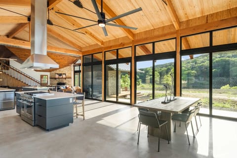 Modern kitchen and dining with panoramic views-cook, dine, and relax surrounded by nature and natural light.