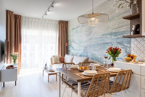 Bright living room with large windows and a corner sofa. The perfect space for Baltic evenings, just by the beach.