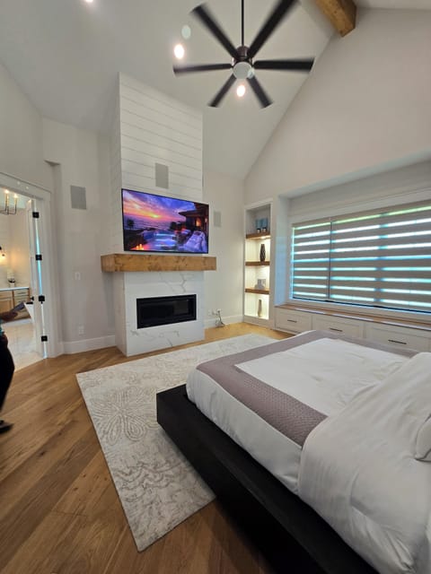 Smart TV in the primary bedroom and a linear fireplace