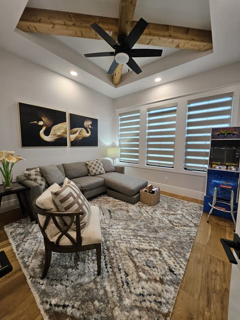 Another view of the gameroom with an arcade mechine.