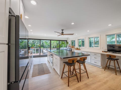 Newly remodeled kitchen is stylish, functional. 10' island with seating for 6-8.