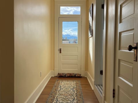Upstairs hallway. Door leads to upstairs deck. Linen closet and bathroom doors.