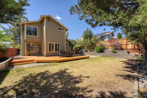 Private backyard with lawn, deck, and room to relax outdoors.