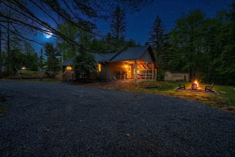 Cabin Exterior at Night with Spacious Gravel Driveway