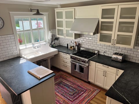Kitchen with farmhouse sink, Wolf gas range, dishwasher.  No garbage disposal