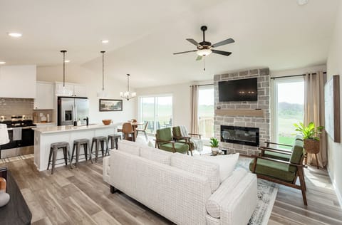Large, vaulted, open concept living area with plenty of seating options 
