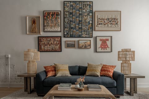 Layered textiles, warm lighting and curated art make this a perfect spot.
