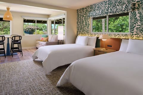 Unwind in bright twin beds with breezy island style.