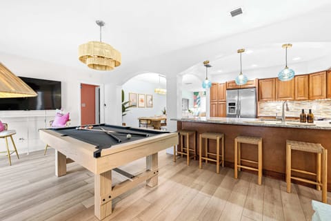 Right beside the kitchen, this modern pool table provides the perfect space for game lovers to enjoy some friendly competition. 