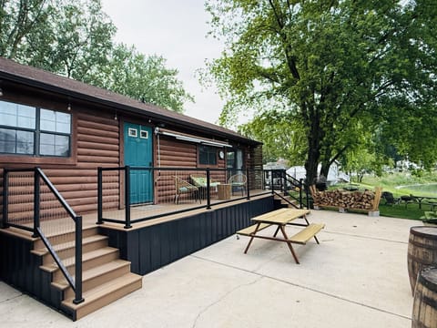 Outdoor deck overlooking the lake with a roll-out awning and cozy seating area.