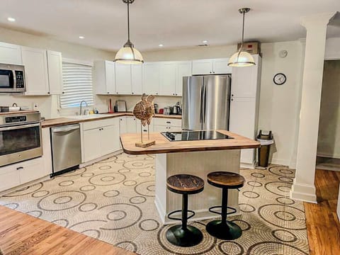 Spacious kitchen with modern appliances and cozy island seating, perfect for culinary gatherings and family meals.