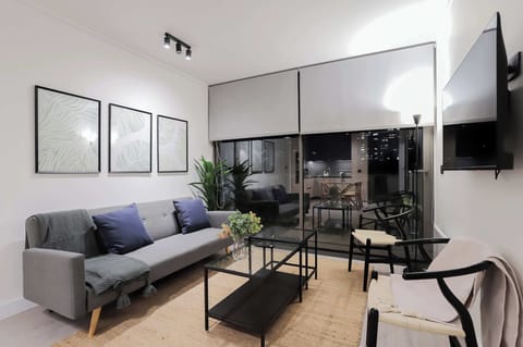 Chic urban living room with stunning city views, perfect for relaxation and entertainment.