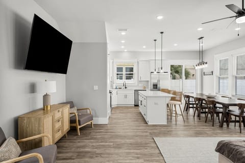 Bright, modern open-concept space with a full kitchen, large dining area, and stylish seating