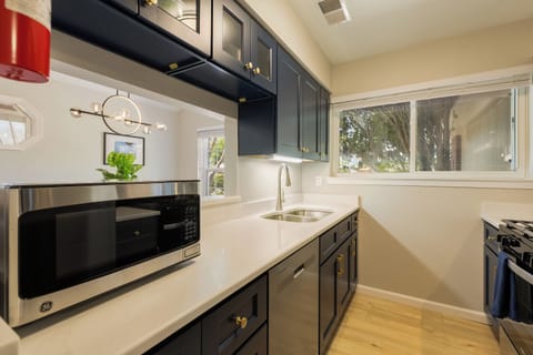 Chef's kitchen with dishwasher and all basic cooking and baking supplies.