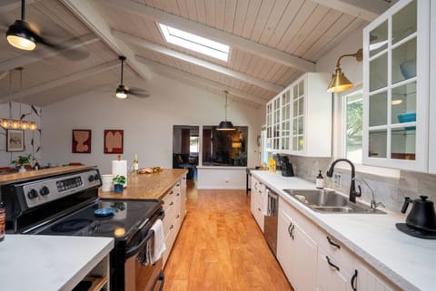 Sun-Drenched Kitchen: Bask in our sun-drenched, fully-stocked kitchen! The perfect heart of the home for gathering, cooking, and making every moment shine with friends.