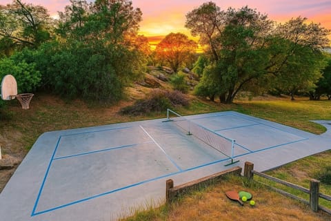 Serve up some fun! 🌅 This private pickleball court, nestled amidst nature with a stunning sunset backdrop, is ready for endless matches and unforgettable moments. Who's ready to play? #PickleballLife #PrivateCourt #SunsetVibes 