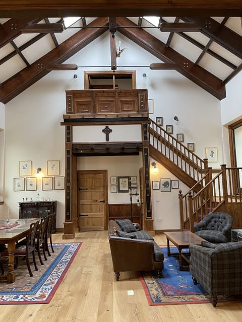 Great room with dining and sitting area. Door at back leads to main bedroom