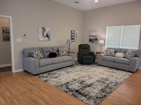 Spacious living area with new sofa, love seat and massaging recliner
