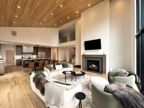 Open concept living room with Gas fireplace + 60' smart TV with Sonos