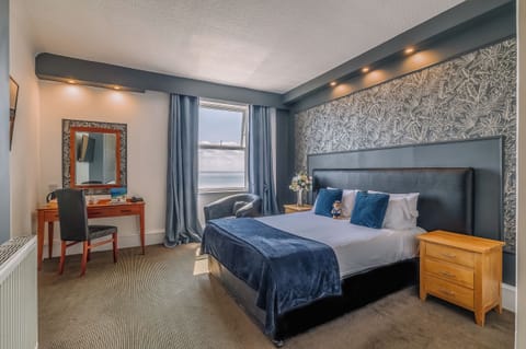 Relax in a stylish room with plush throws and soft lighting.