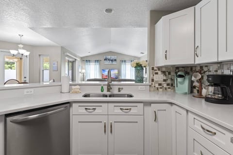 Kitchen featuring both a Keurig and a drip coffee maker, offering options for every coffee lover.