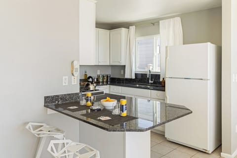 Fully equipped kitchen with modern appliances and ample counter space. (Cayucan Bungalow 224)