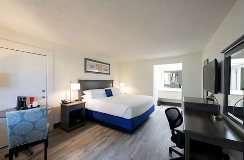 Unwind in a crisp king bed with sleek workspace.