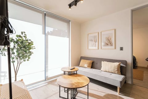Bright and cozy living room with modern decor and natural light, perfect for relaxation.