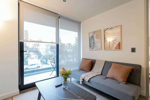 Relax in this cozy living room with a view, featuring stylish decor and a comfortable sofa for unwinding.