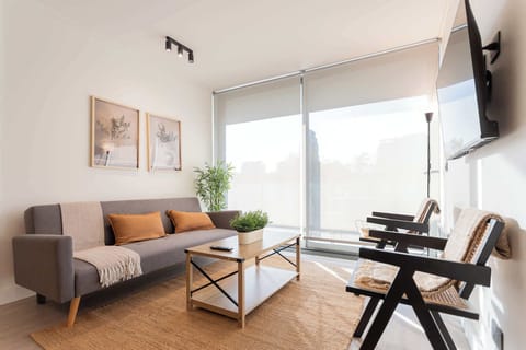 Bright and modern living room with stylish decor, perfect for relaxation and enjoying natural light.