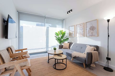 Bright and inviting living room with modern decor, perfect for relaxation and enjoying natural light.
