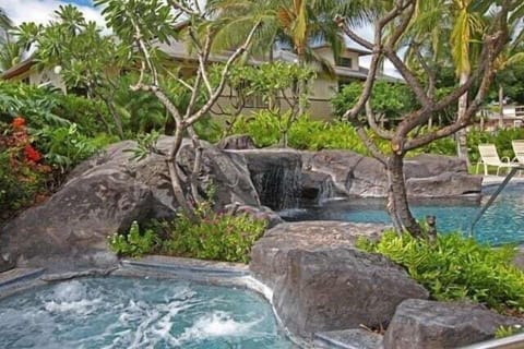 Soak beneath tropical trees in the jetted spa or take a dip beside the soothing rock waterfall.