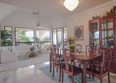 Open concept layout with formal dining and living areas flooded with natural light and island charm.