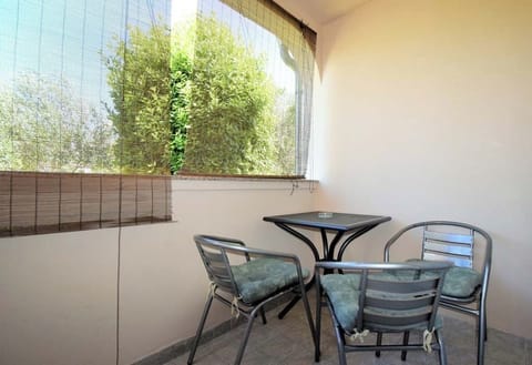 Outdoor terrace with seating and garden view.