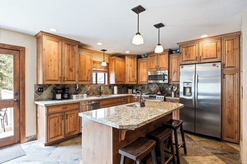 - Modern rustic kitchen with granite countertops and wood cabinetry  
- Stainless steel appliances and island seating perfect for group meals  
- Fully equipped setup makes cooking and entertaining easy
