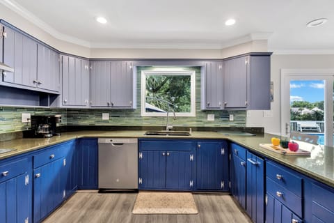 Fully equipped kitchen with stainless steel appliances and ample pantry space
