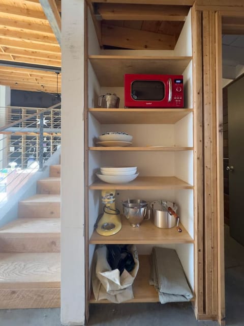 Ample shelving space for your essentials, including a microwave and kitchenware for your convenience.