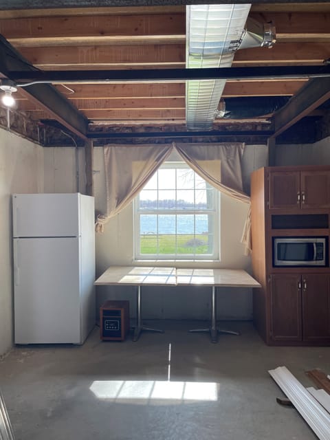 Basement kitchenette offers a refrigerator, counter space, pantry and microwave