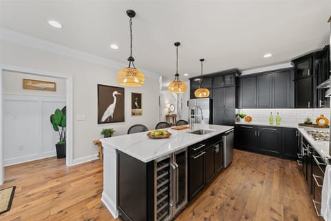 Kitchen includes under the counter beverage refrigerator.